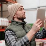 Barcode scanner types in use as a handheld reader captures stock codes in a warehouse