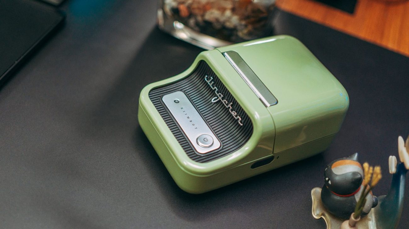 Compact thermal label printer on a desk producing printed labels