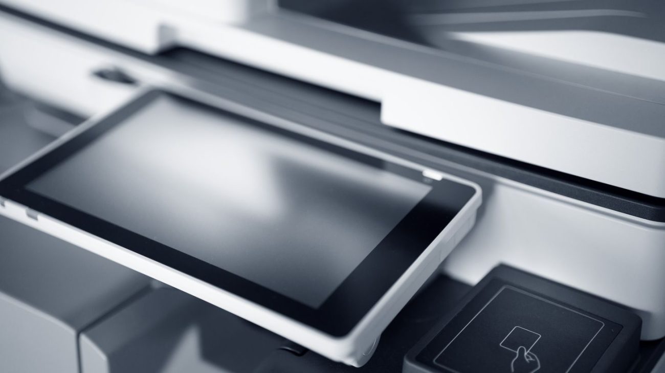 Modern printer with a touchscreen control panel in a print shop