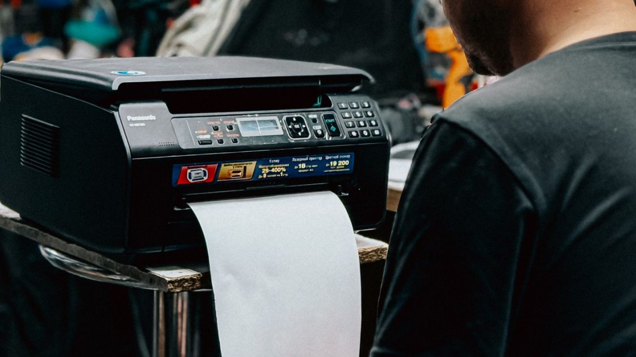 Operator running a label printer in a busy workshop