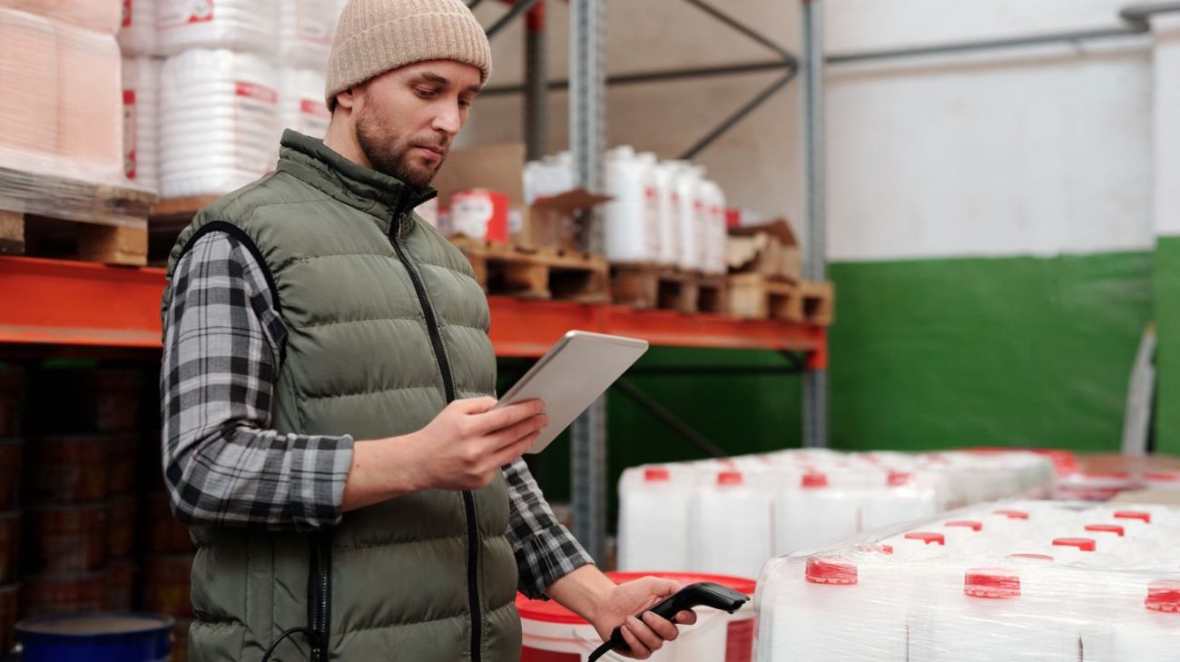 Operations manager planning a barcode label rollout on a tablet in a warehouse