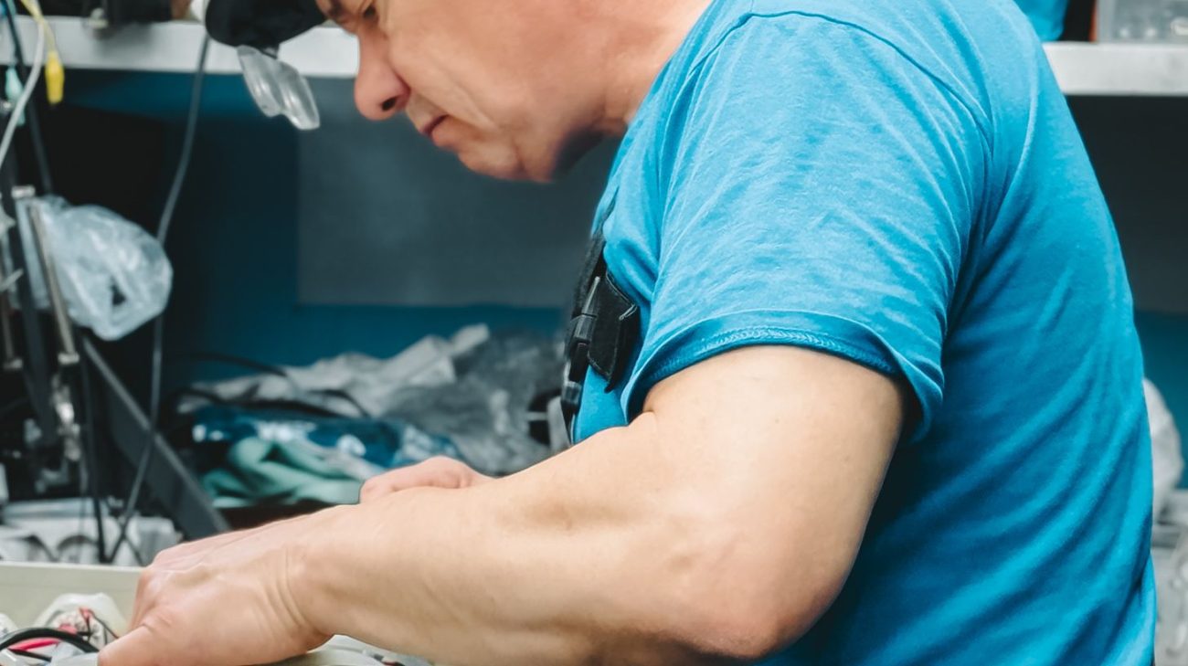 Precision service work being carried out on printer electronics