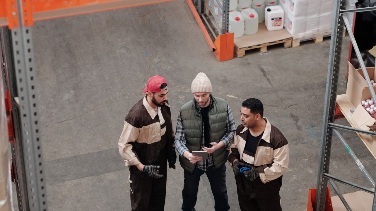 Operations staff discussing tagging locations beside racking