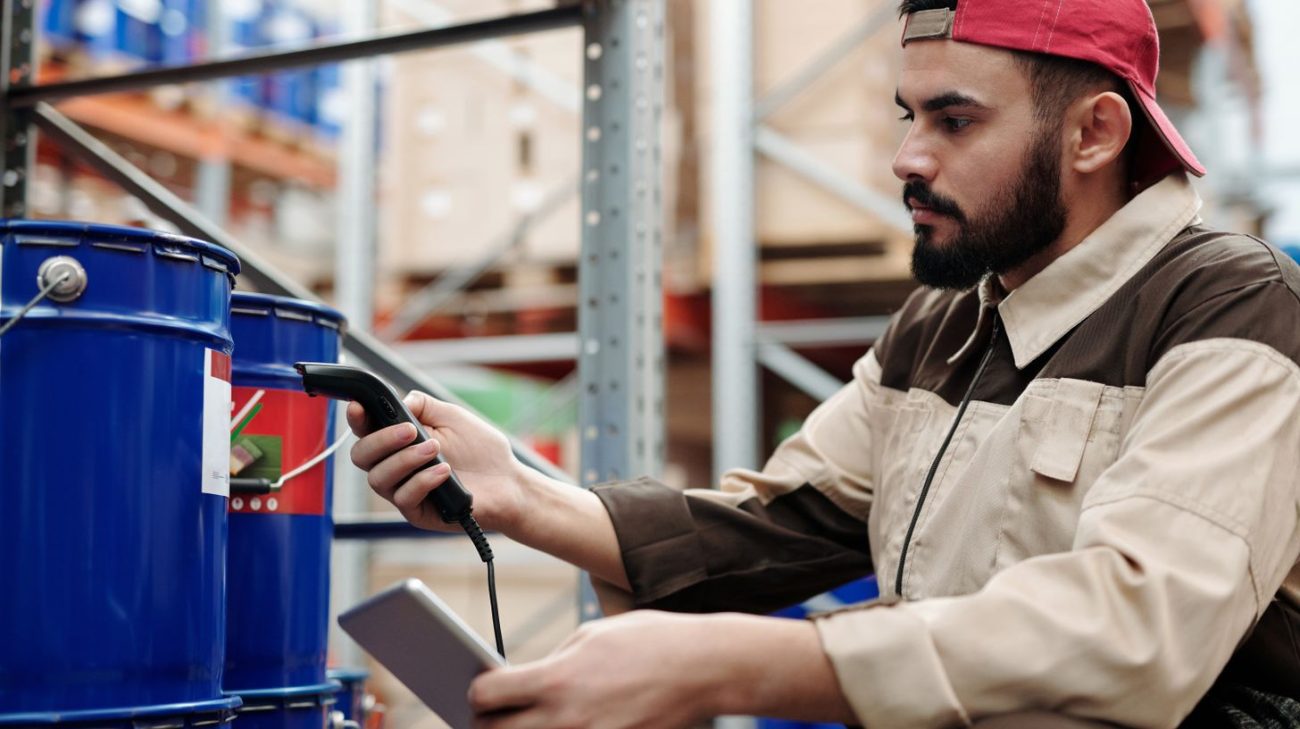 Operator scanning metal drums where reads are hardest