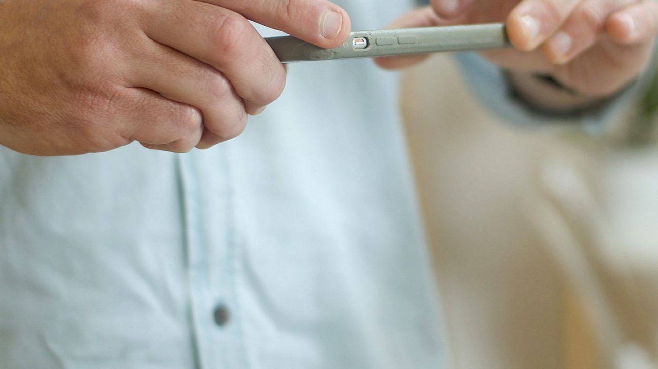 Shopper using a smartphone to scan a QR Code powered by GS1 on a product package