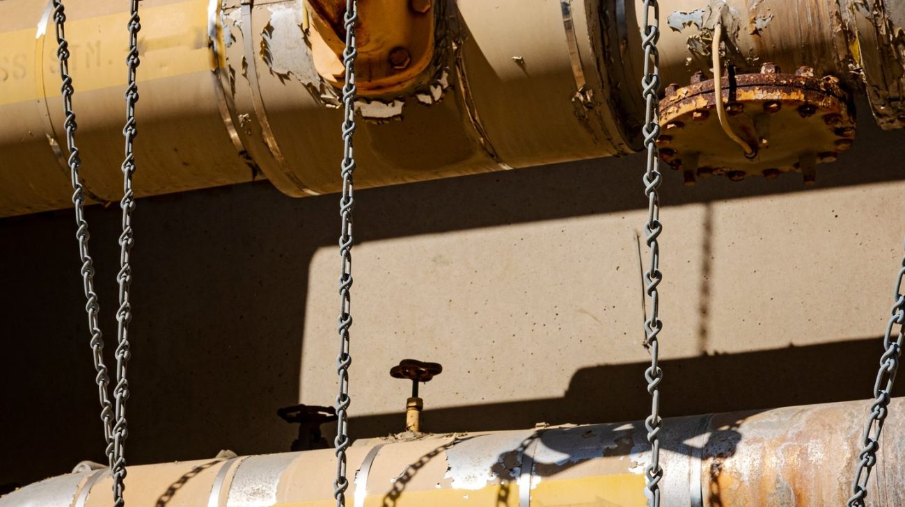 Suspended metal cylinder with valve fittings